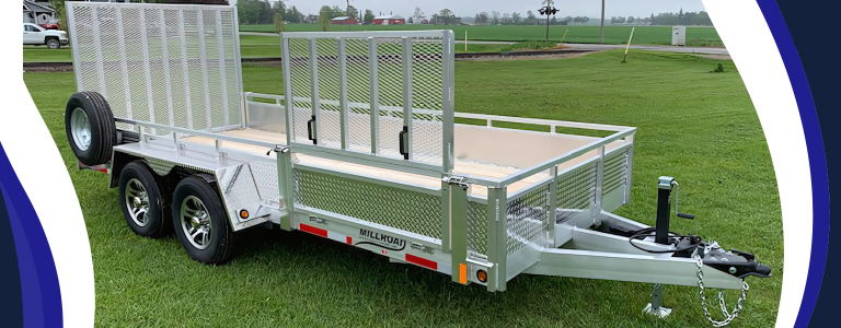 Millroad aluminum landscape trailer with dual axles and mesh loading ramp on grass field